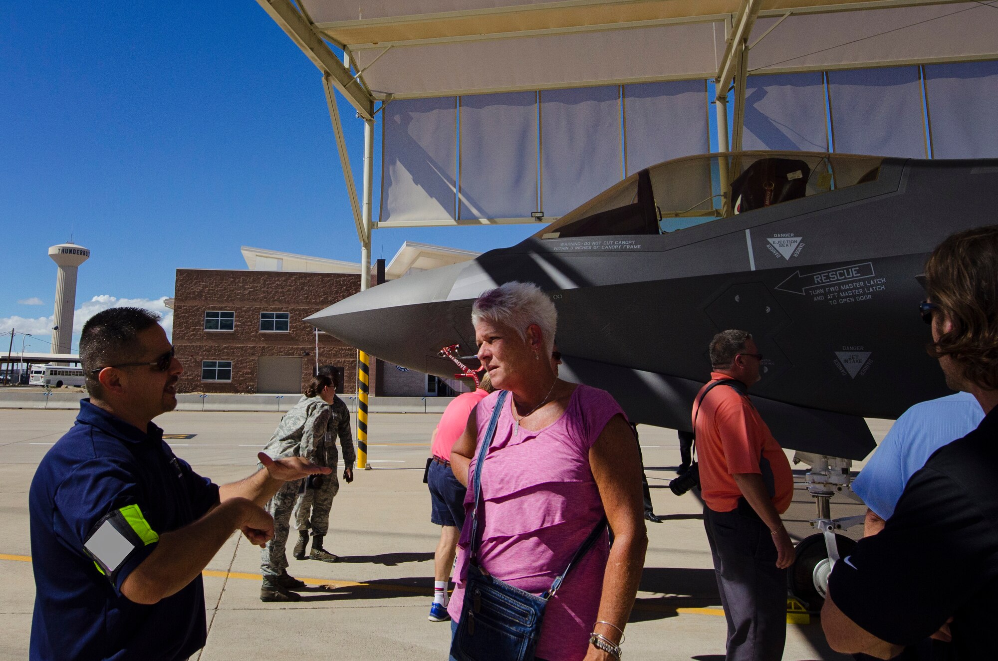 A Team Dover Honorary Commander, Dawne Nickerson-Banez (right), listens as a contractor from Lockheed Martin explain the technological advances of the F-35 Lightning II during a Civic Leader Tour, Sept. 16 on Luke Air Force Base, Ariz. CRTs are designed to engage local leaders from the Dover community with unique missions from different military bases outside of the Air Mobility Command. (U.S. Air Force photo by Capt. Bernie Kale)