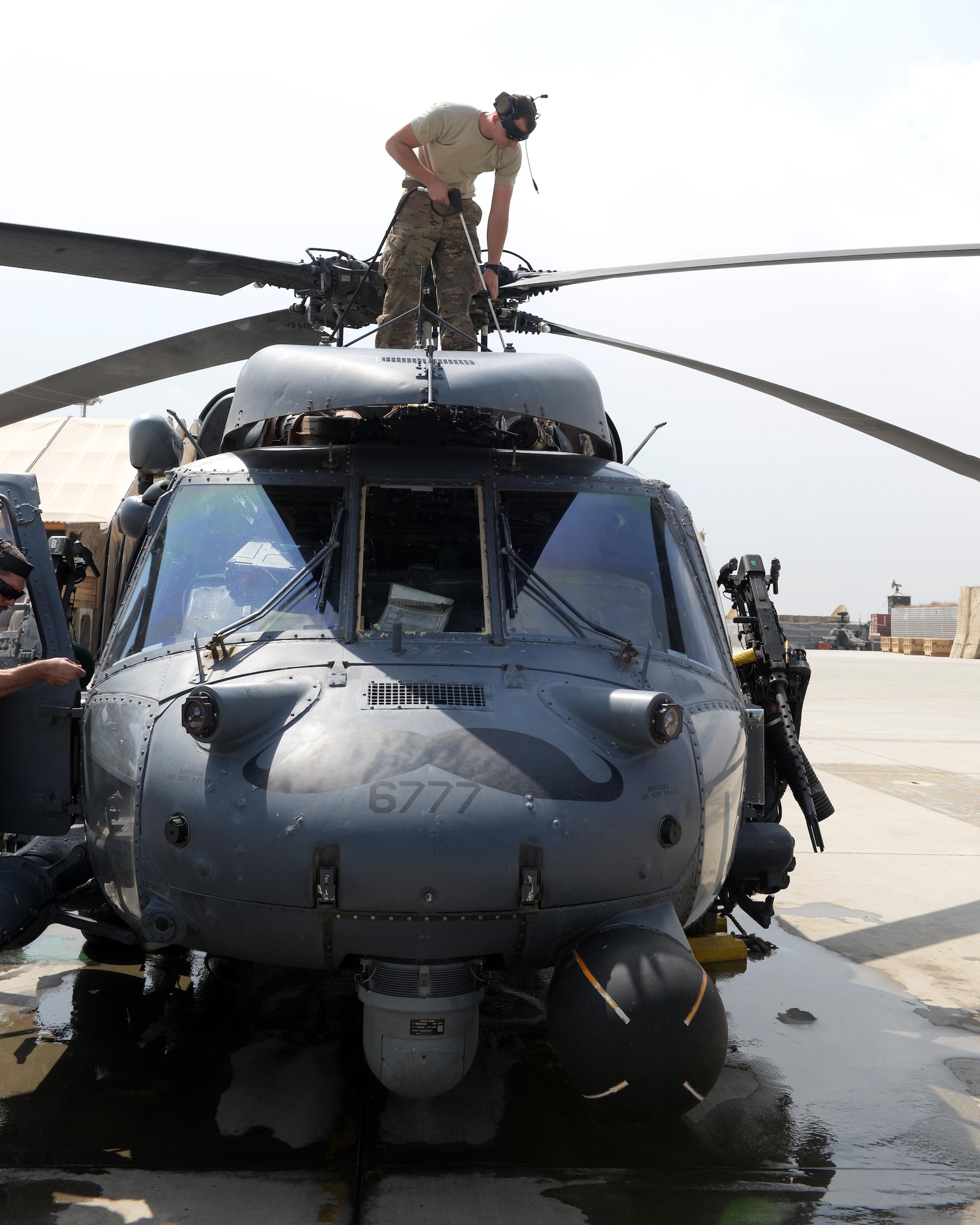 U.S. Air Force Senior Airman Lawrence Turner, 455th Expeditionary Aircraft Maintenance Squadron HH-60G Pave Hawk crew chief, power washes a helicopter Sept. 19, 2015, at Bagram Airfield, Afghanistan. Turner is responsible for performing maintenance on the HH-60G helicopter ensuring it stays operable to perform the mission. (U.S. Air Force photo by Senior Airman Cierra Presentado/Released)