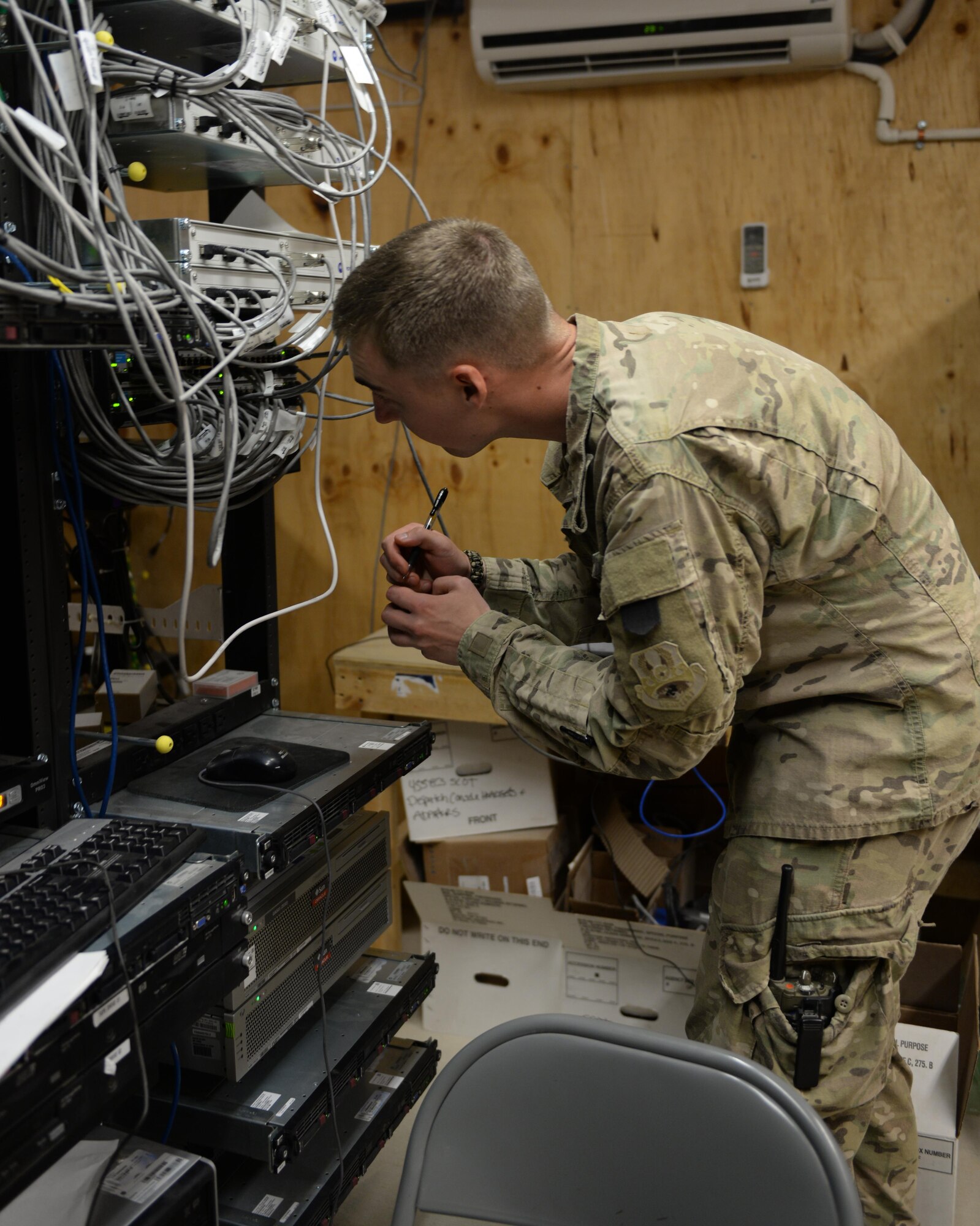 U.S. Air Force Senior Airman Caleb McKinney, 455th Expeditionary Communications Squadron radio frequency transmissions systems technician, works on a radio system Sept. 23, 2015, at Bagram Airfield, Afghanistan. McKinney is responsible for ensuring all radio systems to include air to ground radios, on Bagram remain operable at all times ensuring the mission is carried out on a daily basis. (U.S. Air Force Senior Airman Cierra Presentado/Released)