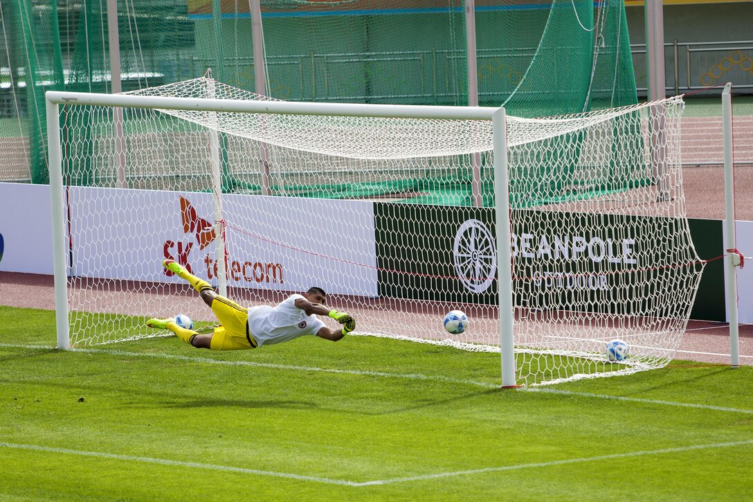 Miguel Cebrero dives to save the ball during a warm up drill before the U.S. men's soccer team against the South Korean men's soccer team during the first round game at the 6th CISM Military World Games in Mungyeong, South Korea, Sept. 30, 2015. U.S. Marine Corps photo by Cpl. Jordan Gilbert