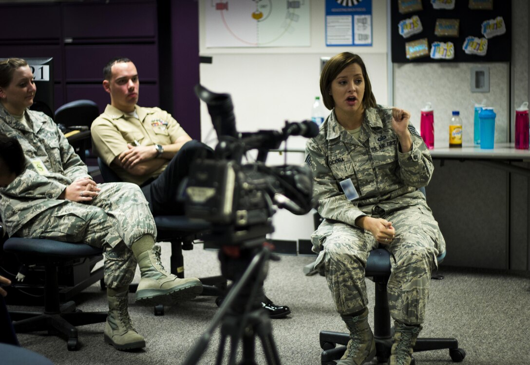 Air Force Staff Sgt. Jaime Ciciora, Broadcast Operations and Maintenance Department instructor, teaches Broadcast Communication Specialist Course students techniques for conducting television interviews during video skills training at the Defense Information School, Fort George G. Meade, Md., September 25th, 2015. BCS teaches students to perform skills in video documentation and broadcast journalism. (DoD photo by Tech. Sgt. Nicholas Kurtz/Released)