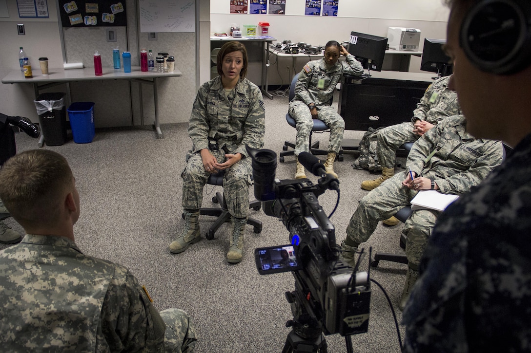 Air Force Staff Sgt. Jaime Ciciora, Broadcast Operations and Maintenance Department instructor, teaches Broadcast Communication Specialist Course students techniques for conducting television interviews during video skills training at the Defense Information School, Fort George G. Meade, Md., September 25th, 2015. BCS teaches students to perform skills in video documentation and broadcast journalism. (DoD photo by Tech. Sgt. Nicholas Kurtz/Released)