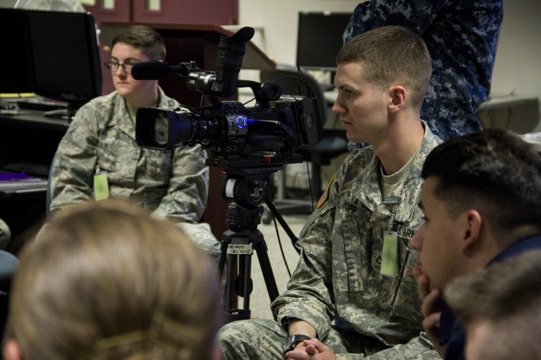 Army Pfc. Dylon Hopp, Broadcast Communication Specialist Course student, conducts a television interview with his instructor while his fellow students observe at the Defense Information School, Fort George G. Meade, Md., September 25th, 2015. BCS teaches students to perform skills in video documentation and broadcast journalism. (DoD photo by Tech. Sgt. Nicholas Kurtz/Released)