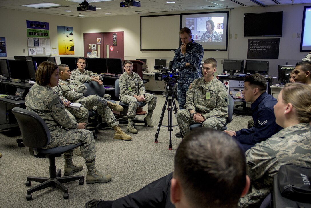Air Force Staff Sgt. Jaime Ciciora (left), Broadcast Operations and Maintenance Department instructor, teaches Broadcast Communication Specialist Course students techniques for conducting television interviews during video skills training at the Defense Information School, Fort George G. Meade, Md., September 25th, 2015. BCS teaches students to perform skills in video documentation and broadcast journalism. (DoD photo by Tech. Sgt. Nicholas Kurtz/Released)
