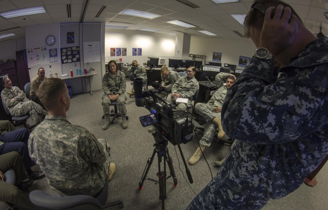 Air Force Staff Sgt. Jaime Ciciora (center), Broadcast Operations and Maintenance Department instructor, teaches Broadcast Communication Specialist Course students techniques for conducting television interviews during video skills training at the Defense Information School, Fort George G. Meade, Md., September 25th, 2015. BCS teaches students to perform skills in video documentation and broadcast journalism. (DoD photo by Tech. Sgt. Nicholas Kurtz/Released)