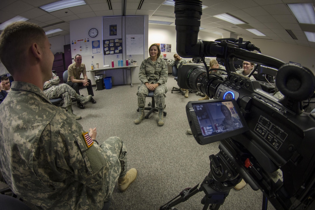 Air Force Staff Sgt. Jaime Ciciora, Broadcast Operations and Maintenance Department instructor (center), teaches Broadcast Communication Specialist Course students techniques for conducting television interviews during video skills training at the Defense Information School, Fort George G. Meade, Md., September 25th, 2015. BCS teaches students to perform skills in video documentation and broadcast journalism. (DoD photo by Tech. Sgt. Nicholas Kurtz/Released)
