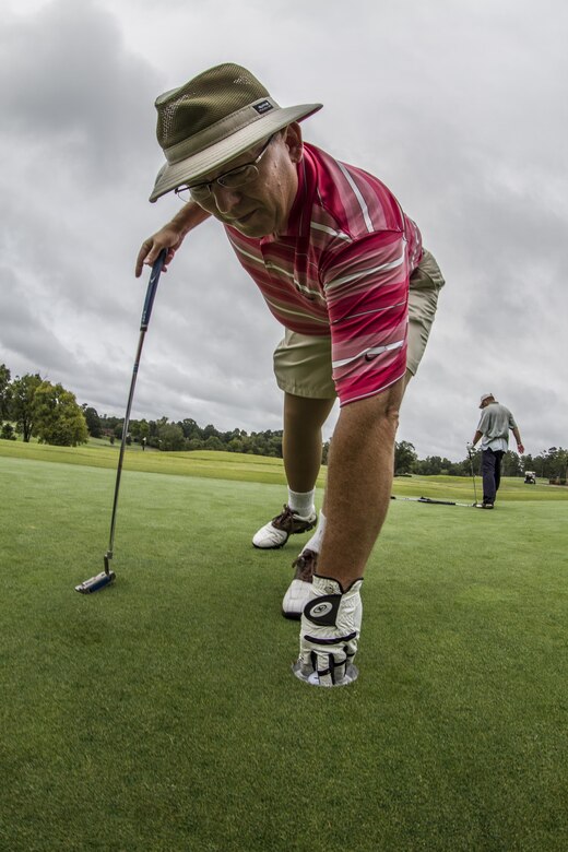 Barry Moore, 108th Training Command (IET) supervisory logistics management specialist, is finally given the opportunity to retrieve his golf ball, while participating in the 5th annual Griffon Association golf tournament at the Pine Island Country Club, in Charlotte, N.C., Sept. 28, 2015. More than 50 Soldiers, veterans and family members participated in the event to raise money for educational scholarships and charity. (U.S. Army photo by Sgt. 1st Class Brian Hamilton)