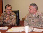 Pakistan Army Col. Shahid Hussain, deputy director of military training, and Lt. Col. Harpreet Baines, U.S. Army Central branch chief for Central and South Asia, discuss future exercise opportunities Sept. 22, 2015, during Inspired Gambit 15. Inspired Gambit is a USARCENT-led exercise held to increase proficiency, expand levels of military-to-military cooperation, and promote long-term regional stability and interoperability.