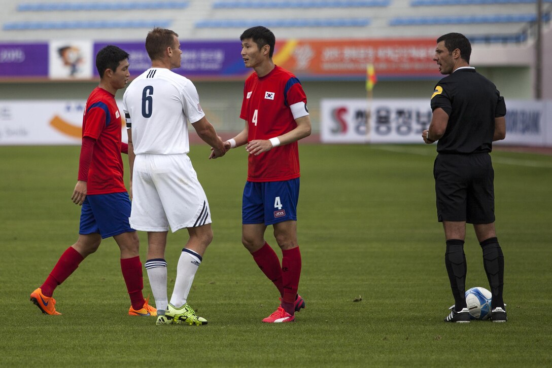 Kevin Rosser, foreground, member of the U.S. men's soccer team, shakes hands with Min Soo Kang of the South Korean team after a play during the first round of the 6th CISM Military World Games in Mungyeong, South Korea, Sept. 30, 2015. U.S. Marine Corps photo by Cpl. Jordan Gilbert

