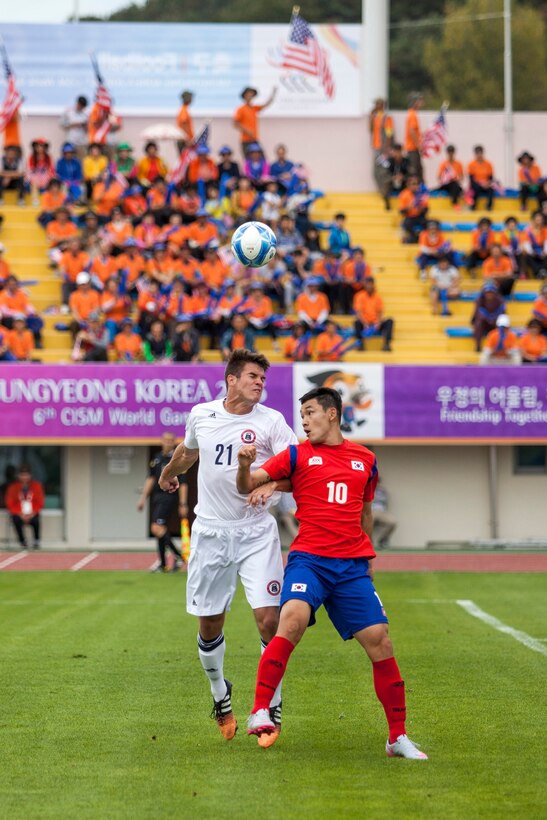 U.S. men's soccer team player Eric Wilson, left, heads the ball away from South Korean player, Dong Kun Jo, during the first round of the 6th CISM Military World Games in Mungyeong, South Korea, Sept. 30, 2015. U.S. Marine Corps photo by Cpl. Jordan Gilbert