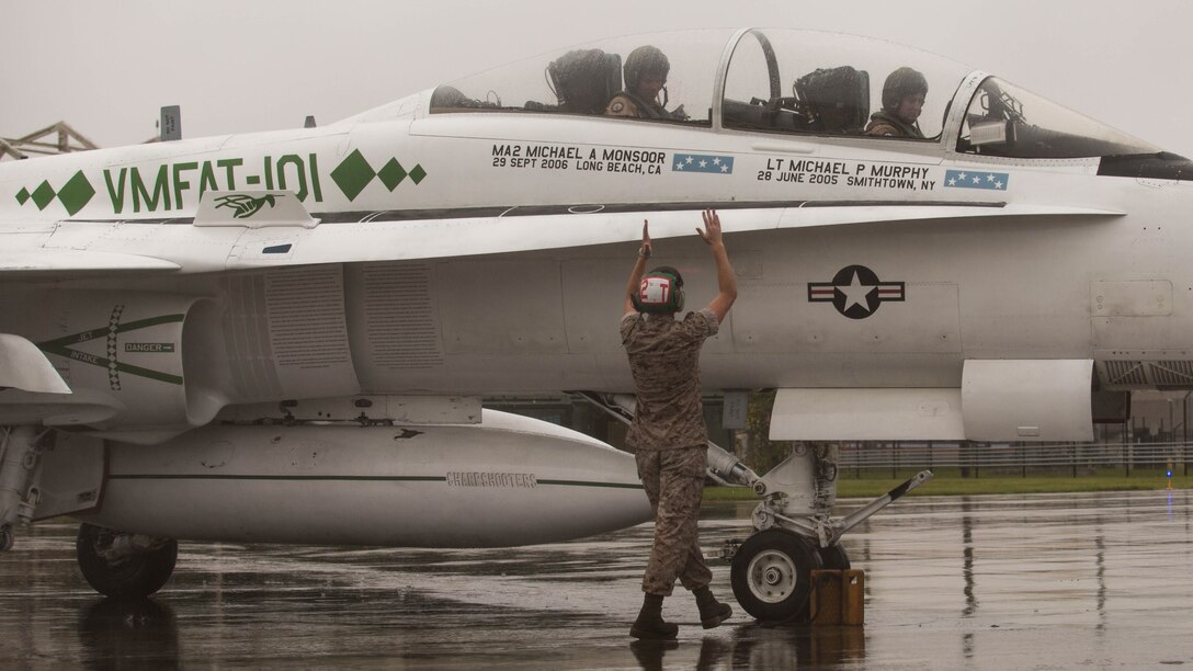 A Marine guides an F/A-18D Hornet on the flight line aboard Marine Corps Air Station Beaufort, South Carolina, Sept. 24. The Hornet is from Marine Corps Air Station Miramar, California, and will train at MCAS Beaufort for three weeks. The Marine is with Marine All Weather Fighter Attack Squadron 533, Marine Aircraft Group 31. The Hornet is with Marine Fighter Attack Training Squadron 101, MAG-11.