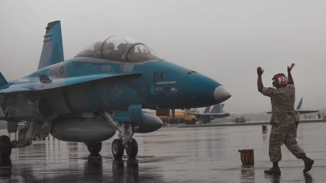 A Marine guides an F/A-18D Hornet on the flight line aboard Marine Corps Air Station Beaufort, South Carolina, Sept. 24.The Hornet is from Marine Corps Air Station Miramar, California, and will train at MCAS Beaufort for three weeks. The Marine is with Marine All Weather Fighter Attack Squadron 533, Marine Aircraft Group 31. The Hornet is with Marine Fighter Attack Training Squadron 101, MAG-11.