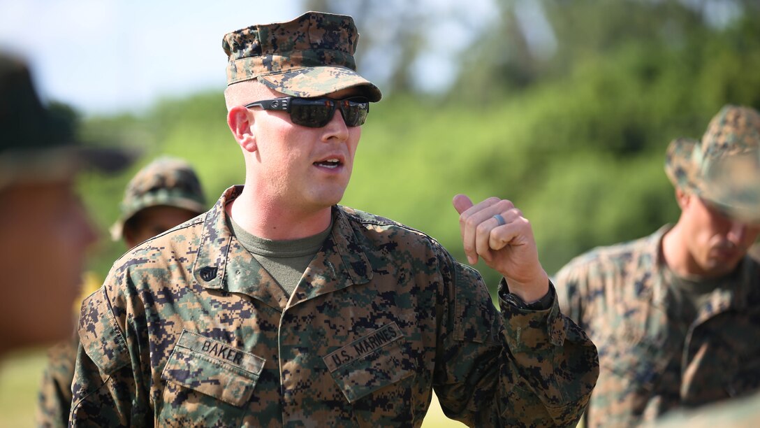 Staff Sgt. Thomas Baker, the logistics chief with 3rd Battalion, 3rd Marine Regiment, and Bowling Green, Kentucky, native, informs the “Trinity” Marines of the plan to move ahead to the forward operating base at the Boondocker Training Area aboard Marine Corps Base Hawaii during training exercise Island Viper, Sept. 22, 2015. The purpose of Island Viper was to help companies within the battalion ensure their service members have been properly trained and have met all training requirements before deployment.