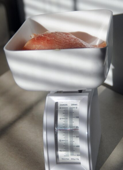 Airman 1st Class Paige Ryser, National Air and Space Intelligence Agency personnel specialist, weighs and prepares her meals Thursday, Sept. 24, 2015 at her home. Ryser follows a strict routine while preparing for her bodybuilding competitions. She works out six days per week and includes lifting, cardio and sprints in her workout routine, along with a strict diet program. (U.S. Air Force photo by Staff Sgt. Marianne E. Lane)