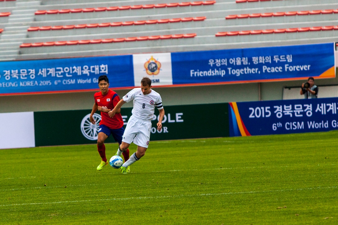 U.S. Men’s soccer team player Kevin Rosser, right, steals the ball from a South Korean men’s soccer player and dribbles it down the field during the first round of the 6th CISM Military World Games in Mungyeong, South Korea, Sept. 30, 2015. U.S. Marine Corps photo by Sgt. Ashley Cano

