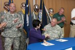 U.S. Army Brig. Gen. R. Van McCarty, deputy adjutant general for South Carolina National Guard, joins with Aiken Technical College President Dr. Susan Windsor to sign the Department of Labor grant for the South Carolina Youth Challenge Academy's POST Job Challenge at Aiken Technical College, Sept. 16, 2015. POST Job Challenge will afford Youth Challenge graduates the opportunity to continue their education at Aiken Tech. 