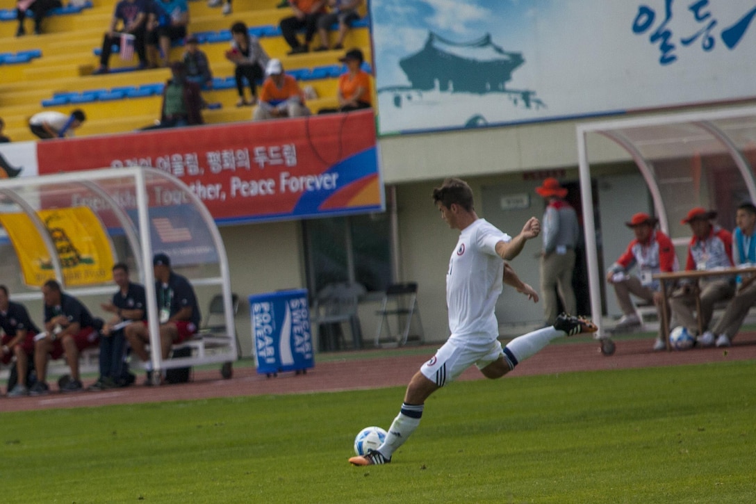 A member of the U.S. men’s soccer team prepares to kick the ball against the South Korean men’s soccer team during the first round of the 6th CISM Military World Games in Mungyeong, South Korea, Sept. 30, 2015. U.S. Marine Corps photo by Sgt. Ashley Cano