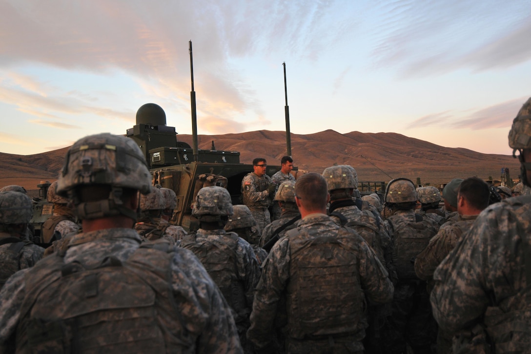 U.S. Army Capt. Larry Harris, center, briefs his soldiers before the start of Rising Thunders culminating a live-fire exercise at Yakima Training Center, Wash., Sept. 21, 2015. Harris is assigned to the 2nd Infantry Division’s 4th Battalion, 23rd Infantry Regiment, 2nd Stryker Brigade. U.S. Army photo by Sgt. Eliverto Larios