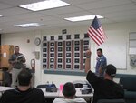 DLA Distribution San Joaquin Freight Terminal employees participate in Audit Readiness Jeopardy. The game aims to help employees to retain audit readiness knowledge in preparation for the upcoming Independent Public Accountant audit scheduled for 2016. Pictured, far left, is day shift supervisor Wayne Butler, game facilitator, and, standing on right, Freight Terminal Branch Chief Henry Martin, serving as score keeper.