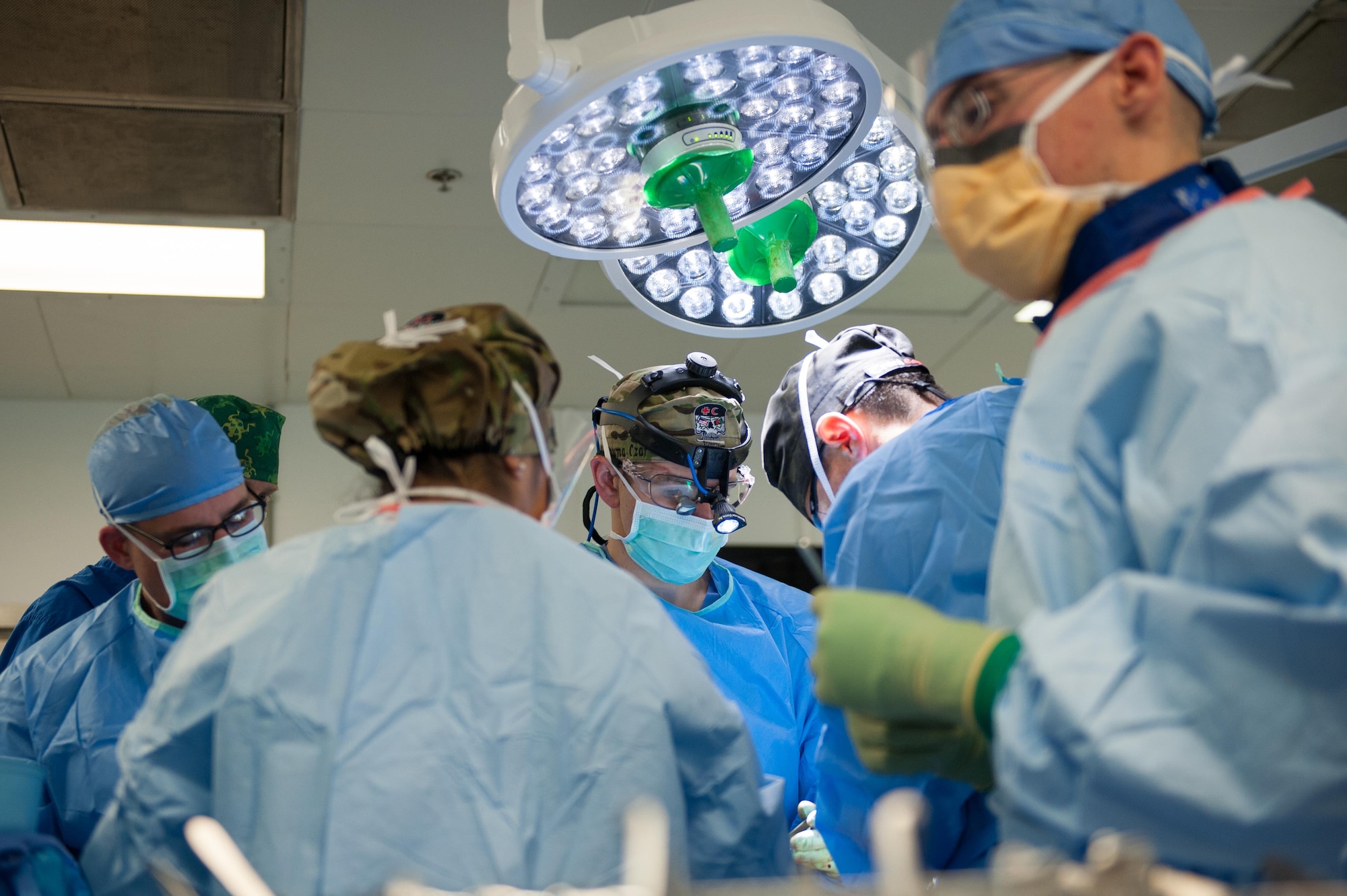 U.S. Airmen assigned to the 455th Expeditionary Medical Group perform surgery for gunshot trauma on an Afghan National Defense and Security Forces soldier at the Craig Joint Theater Hospital, Bagram Airfield Afghanistan, Sept. 26, 2015. The CJTH provides surgical capabilities in trauma, general surgery, orthopedics, neurosurgery, urology, vascular surgery and otolaryngology, all of which are critical to helping 98 percent of patients who come to the hospital survive their injuries. (U.S. Air Force photo by Tech. Sgt. Joseph Swafford/Released)