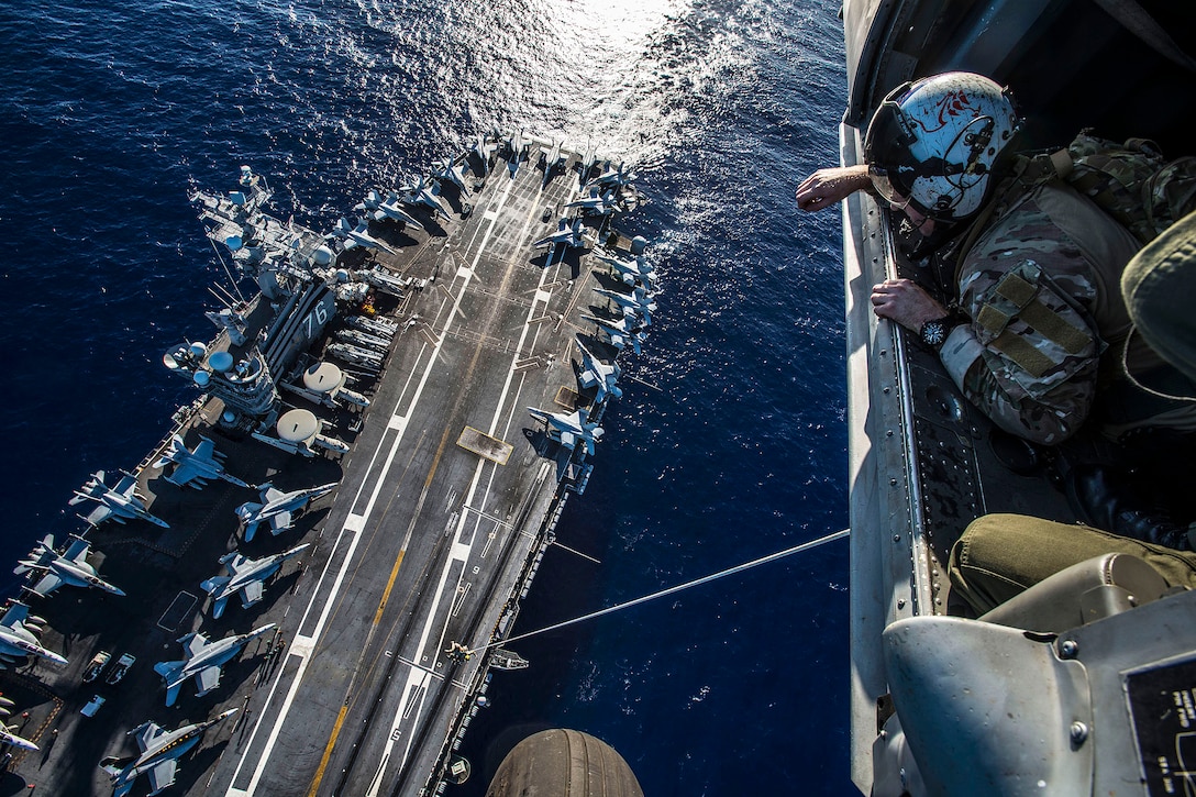 U.S. Navy sailors conduct an insertion and extraction exercise aboard the aircraft carrier USS Ronald Reagan in Iwo To, Japan, Sept. 29, 2015. The ship, and its embarked air wing, Carrier Air Wing 5, provide a combat-ready force to protect the collective maritime interests of the United States and its partners in the Indo-Asia-Pacific region. The sailors are assigned to Explosive Ordnance Disposal Mobile Unit 5. U.S. Navy photo by Petty Officer 2nd Class Paolo Bayas