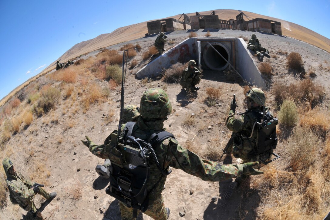 Japanese soldiers assault a village during the culminating live-fire exercise of Exercise Rising Thunder at Yakima Training Center, Wash., Sept. 21, 2015. The Japanese soldiers are assigned to the Japan Ground Self-Defense Force. U.S. Army photo by Sgt. Eliverto Larios