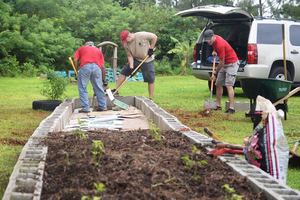 Airmen assigned to the 554th RED HORSE Squadron expand a garden Sept. 26, 2015, at the Guma San Jose Homeless Shelter in Dededo, Guam. The team offered specialized services to assist with the shelter’s electrical, plumbing and air conditioning issues. Crews also expanded a garden to allow residents to grow their own fruits and vegetables and develop healthy eating habits. (U.S. Air Force photo/Senior Airman Joshua Smoot)