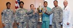 BAMC Commander Col. Evan Renz (far right) and Command Sgt. Maj. Tabitha Gavia (far left) present the Commander’s trophy to representatives from the neurology clinic for their contributions to patient satisfaction during a ceremony at San Antonio Military Medical Center Sept. 15. Neurology personnel are (from left) Air Force Maj. Wendy Chao, Esther Martinez, Tech. Sgt. Nessie Deguzman and Sgt. 1st Class Carlos Alonso.