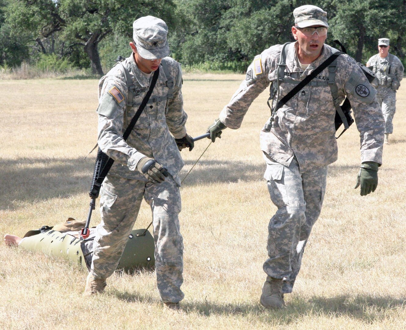 Army Spc. Garrett Woodford (left) and Army Sgt. 1st Class Stephen Eisele (right) pull a skid with a 165-pound dummy simulating a casualty during the Southern Regional Medical Command Best Medic Competition Sept. 18 at Camp Bullis.