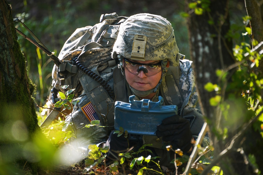 A U.S. soldier sets up a mine during the Joint Multinational Readiness Center's competition for an expert infantryman badge on the Hohenfels Training Area, Germany, Sept. 29, 2015. U.S. Army photo by Markus Rauchenberger