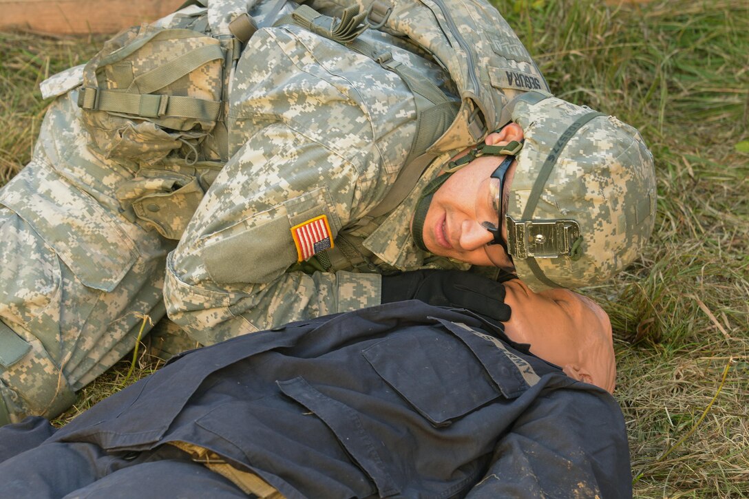 U.S. Army Expert Infantryman Badge candidate Spc. Derek Segura performs first aid on a simulated casualty during the Joint Multinational Readiness Center's competition on the Hohenfels Training Area, Germany, Sept. 29, 2015. U.S. Army photo by Markus Rauchenberger