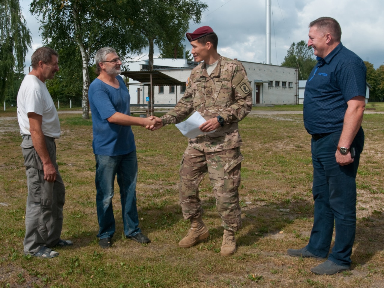 U.S. Army Pfc. Aidarbek Raev, a unit supply specialist with Dog Company, 1st Battalion, 503rd Infantry Regiment, talks with military contractors about a construction project in Panevezys, Lithuania, Aug. 26, 2015. Raev, a native of Bishkek, Kyrgyzstan, is fluent in Russian, the second-most common language in Lithuania. Raev’s language skills helped ease communication barriers between U.S. soldiers and host nation allies. U.S. Army photo by Sgt. Jarred Woods