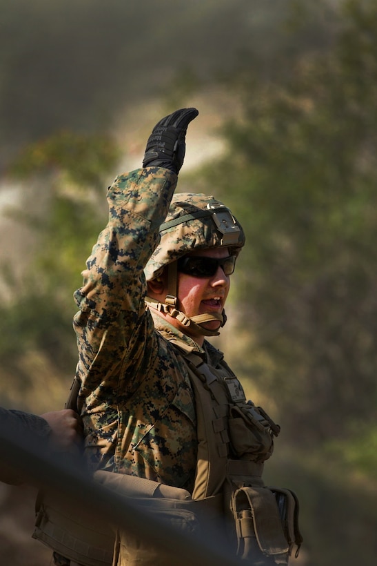 A U.S. Marine signals preparation to fire an M777-A2 howitzer during a direct-fire exercise at Novo Selo Training Area, Bulgaria, Sept. 22, 2015. The Marines are assigned to Combined Arms Company and have prepared for multinational training exercises over the next few months. U.S. Marine Corps photo by Lance Cpl. Melanye E. Martinez