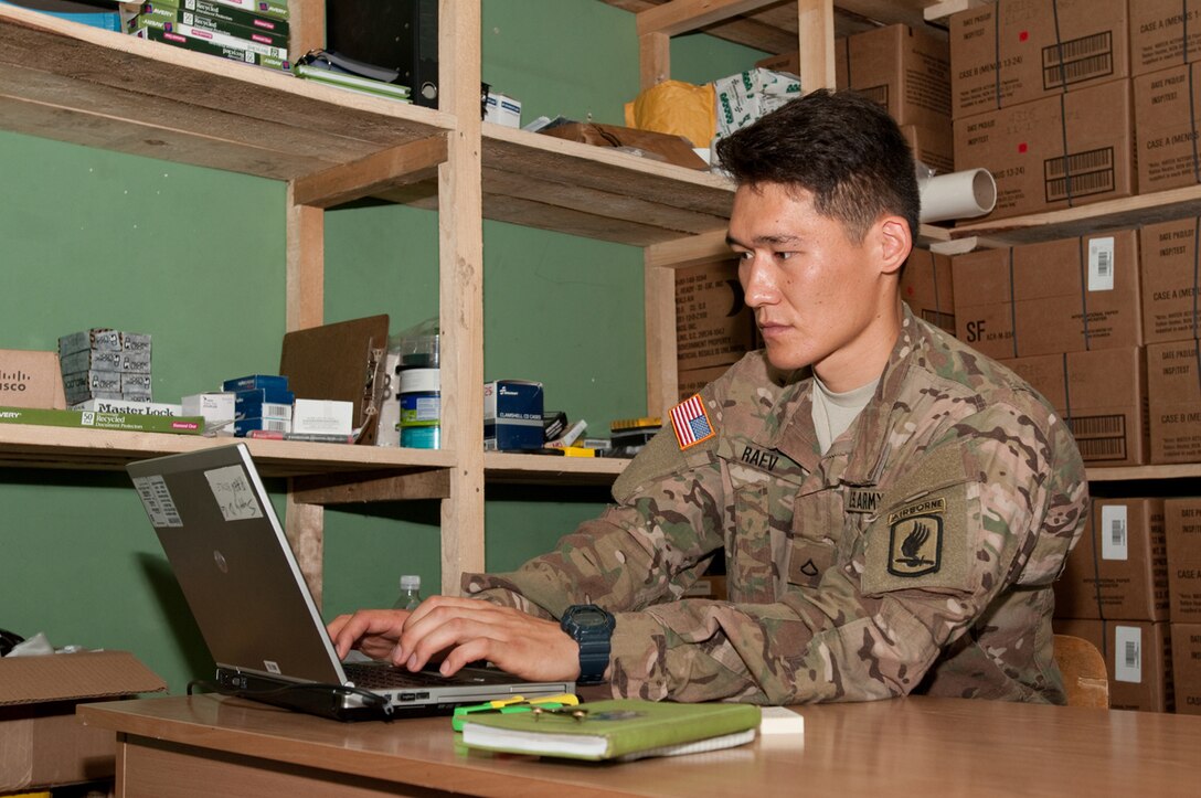 U.S. Army Pfc. Aidarbek Raev, a unit supply specialist with Dog Company, 1st Battalion, 503rd Infantry Regiment, updates unit supply inventory records in Panevezys, Lithuania, Aug. 26, 2015. Raev, a native of Bishkek, Kyrgyzstan, is Dog Company’s supply specialist and performs the duties and responsibilities of a soldier three tiers above his current rank. U.S. Army photo by Sgt. Jarred Woods