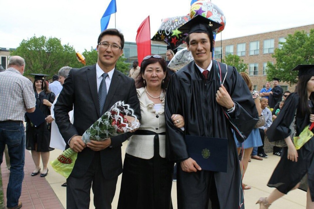 Aidarbek Raev, a native of Bishkek, Kyrgyzstan, poses with his mother and older brother on his graduation day at Camden Community College in Blackwood, N.J., May 2013. Raev is now an Army private first class and a unit supply specialist with Dog Company, 1st Battalion, 503rd Infantry Regiment. Courtesy photo