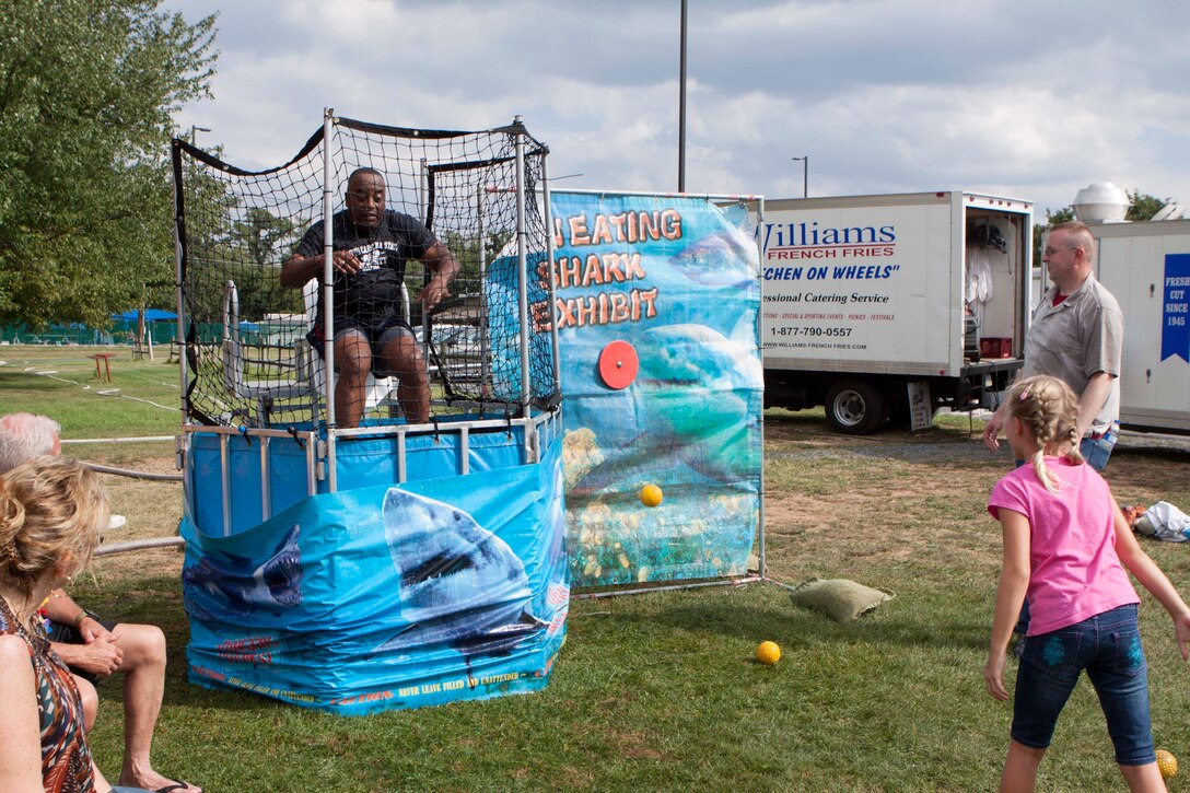 DLA Distribution commander Army Brig. Gen. Richard Dix falls into the water at DLA Distribution Organizational Day’s dunk tank. Photo by Jessica Roman.