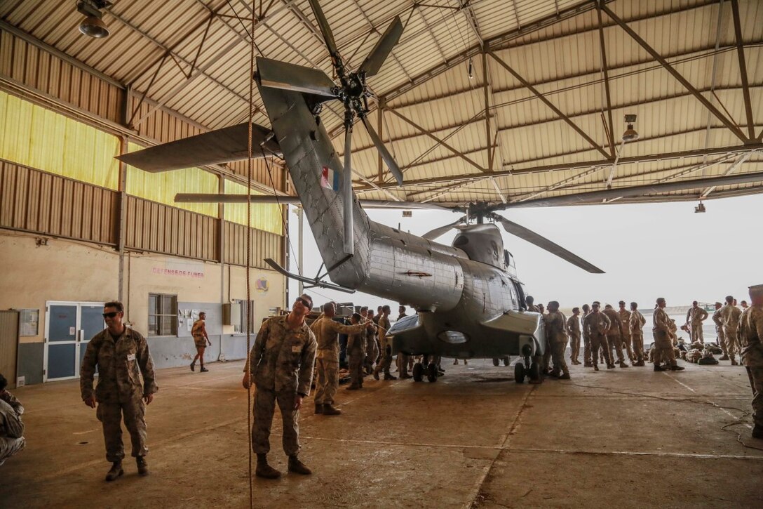 BASE AERIENNE 188, Djibouti (Sept. 21, 2015) U.S. Marines with the 15th Marine Expeditionary Unit get an overview of the capabilities and structure of a French Aérospatiale SA 330 Puma helicopter. Elements of the 15th MEU are training with the 5th RIAOM in Djibouti in order to improve interoperability between the MEU and the French military. (U.S. Marine Corps photo by Sgt. Steve H. Lopez/Released)