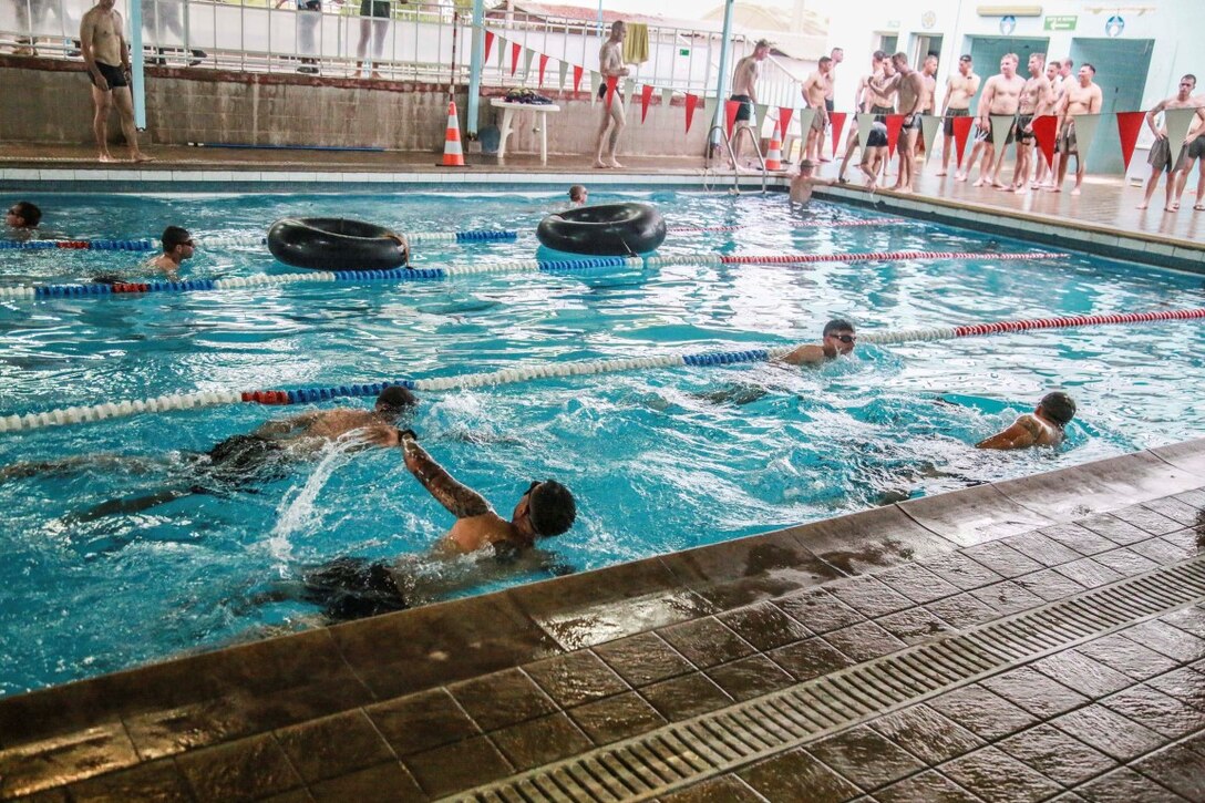 U.S. Marines with the 15th Marine Expeditionary Unit and the French 5th Overseas Combined Arms Regiment (RIAOM) execute the swim portion of the indoctrination prior to participating in a desert survival course. Elements of the 15th MEU are training with the 5th RIAOM in Djibouti in order to improve interoperability between the MEU and the French military. (U.S. Marine Corps photo by Sgt. Steve H. Lopez/Released)
