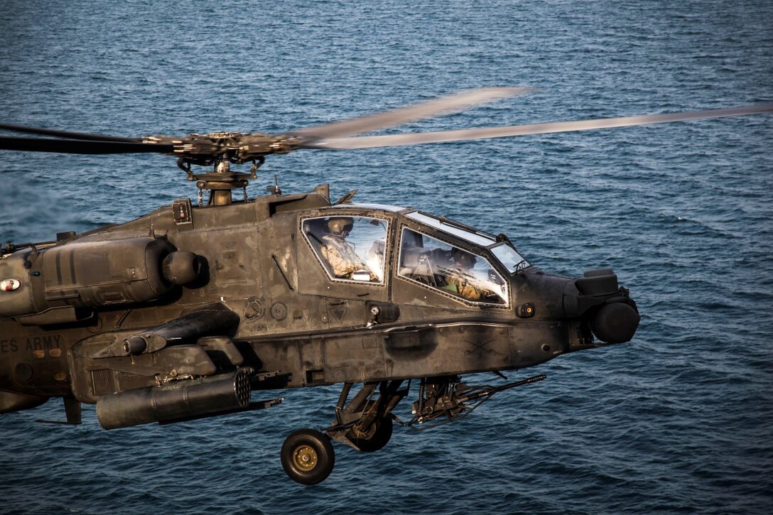ARABIAN GULF (Sept. 29, 2015) An AH-64 Apache with the U.S. Army’s 185th Theater Aviation Brigade prepares to land aboard the amphibious assault ship USS Essex (LHD 2). These Soldiers practiced landing and departing from the Essex in order to familiarize themselves with flight operations aboard a ship. The 15th Marine Expeditionary Unit, embarked aboard the ships of the Essex Amphibious Ready Group, is deployed to maintain regional security in the U.S. 5th Fleet area of operations. (U.S. Marine Corps photo by Cpl. Elize McKelvey/Released)