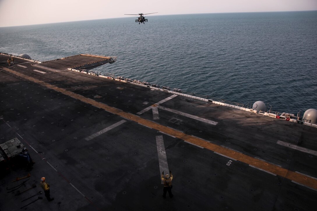 ARABIAN GULF (Sept. 29, 2015) An AH-64 Apache with the U.S. Army’s 185th Theater Aviation Brigade prepares to land aboard the amphibious assault ship USS Essex (LHD 2). These Soldiers practiced landing and departing from the Essex in order to familiarize themselves with flight operations aboard a ship. The 15th Marine Expeditionary Unit, embarked aboard the ships of the Essex Amphibious Ready Group, is deployed to maintain regional security in the U.S. 5th Fleet area of operations. (U.S. Marine Corps photo by Cpl. Elize McKelvey/Released)