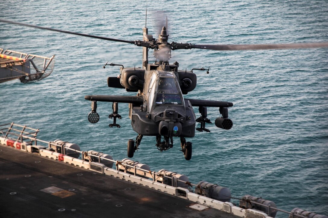 ARABIAN GULF (Sept. 29, 2015) An AH-64 Apache with the U.S. Army’s 185th Theater Aviation Brigade prepares to land aboard the amphibious assault ship USS Essex (LHD 2). These Soldiers practiced landing and departing from the Essex in order to familiarize themselves with flight operations aboard a ship. The 15th Marine Expeditionary Unit, embarked aboard the ships of the Essex Amphibious Ready Group, is deployed to maintain regional security in the U.S. 5th Fleet area of operations. (U.S. Marine Corps photo by Cpl. Elize McKelvey/Released)