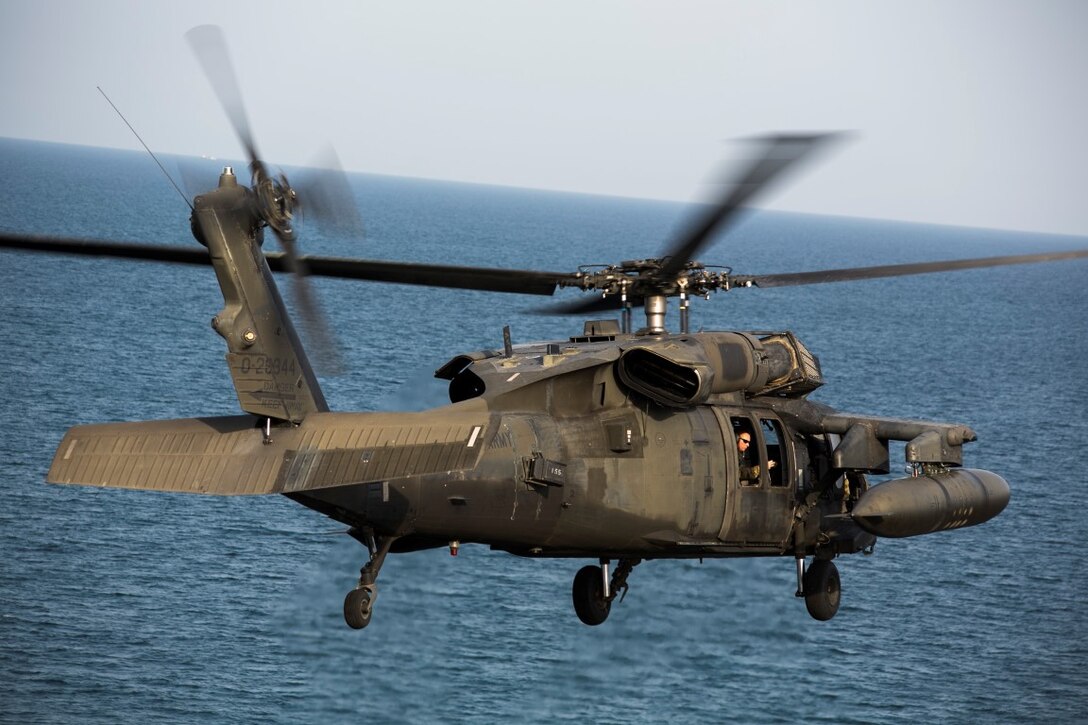 ARABIAN GULF (Sept. 29, 2015) A UH-60 Black Hawk with 185th Theater Aviation Brigade departs the amphibious assault ship USS Essex (LHD 2). These Soldiers practiced landing and departing from the Essex in order to familiarize themselves with flight operations aboard a ship. The 15th Marine Expeditionary Unit, embarked aboard the ships of the Essex Amphibious Ready Group, is deployed to maintain regional security in the U.S. 5th Fleet area of operations. (U.S. Marine Corps photo by Cpl. Anna Albrecht/Released)
