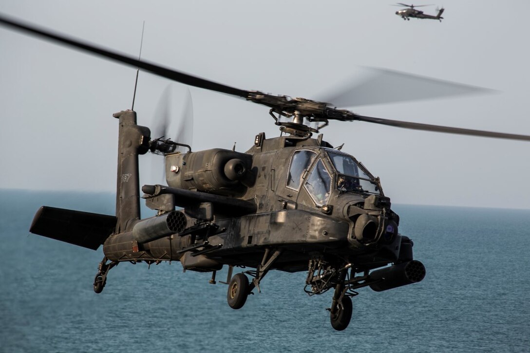ARABIAN GULF (Sept. 29, 2015) An AH-64 Apache with the U.S. Army’s 185th Theater Aviation Brigade prepares to land aboard the amphibious assault ship USS Essex (LHD 2). These Soldiers practiced landing and departing from the Essex in order to familiarize themselves with flight operations aboard a ship. The 15th Marine Expeditionary Unit, embarked aboard the ships of the Essex Amphibious Ready Group, is deployed to maintain regional security in the U.S. 5th Fleet area of operations. (U.S. Marine Corps photo by Cpl. Anna Albrecht/Released)