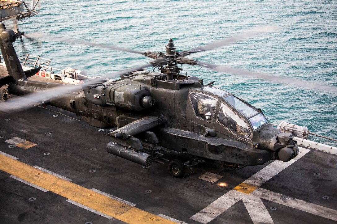 ARABIAN GULF (Sept. 29, 2015) An AH-64 Apache with the U.S. Army’s 185th Theater Aviation Brigade lands aboard the amphibious assault ship USS Essex (LHD 2). These Soldiers practiced landing and departing from the Essex in order to familiarize themselves with flight operations aboard a ship. The 15th Marine Expeditionary Unit, embarked aboard the ships of the Essex Amphibious Ready Group, is deployed to maintain regional security in the U.S. 5th Fleet area of operations. (U.S. Marine Corps photo by Cpl. Anna Albrecht/Released)