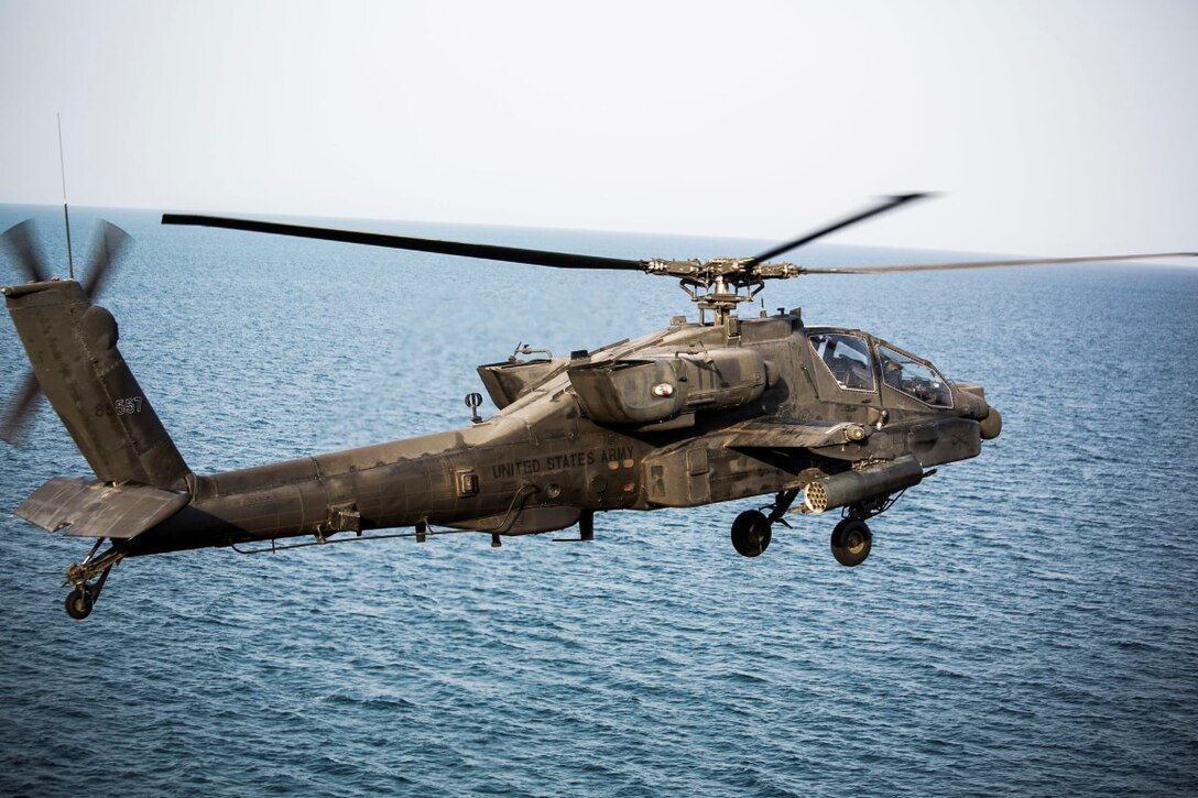ARABIAN GULF (Sept. 29, 2015) An AH-64 Apache with the U.S. Army’s 185th Theater Aviation Brigade departs the amphibious assault ship USS Essex (LHD 2). These Soldiers practiced landing and departing from the Essex in order to familiarize themselves with flight operations aboard a ship. The 15th Marine Expeditionary Unit, embarked aboard the ships of the Essex Amphibious Ready Group, is deployed to maintain regional security in the U.S. 5th Fleet area of operations. (U.S. Marine Corps photo by Cpl. Anna Albrecht/Released)