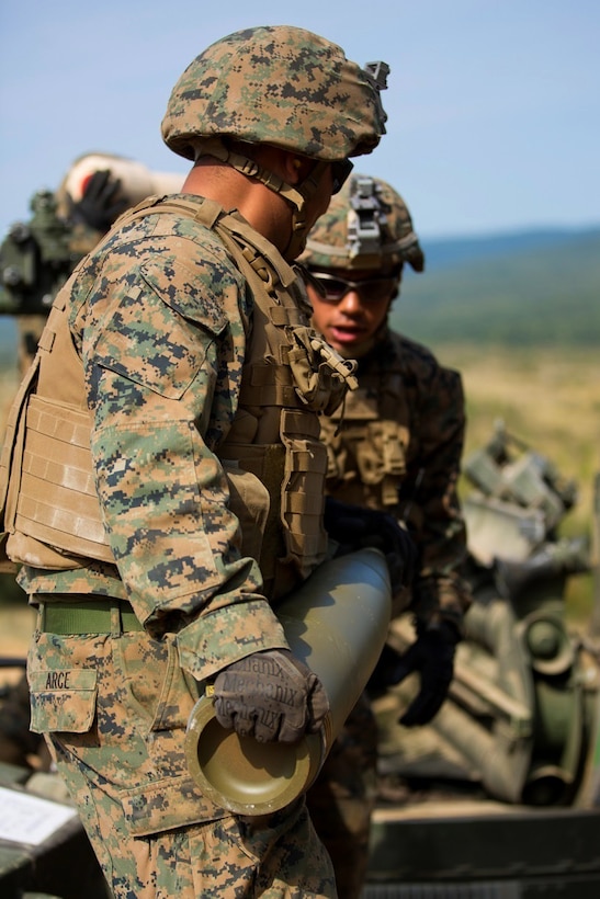 U.S. Marines prepare to load a round into a M777-A2 howitzer during a direct-fire exercise at Novo Selo Training Area, Bulgaria, Sept. 22, 2015. U.S. Marine Corps photo by Lance Cpl. Melanye E. Martinez