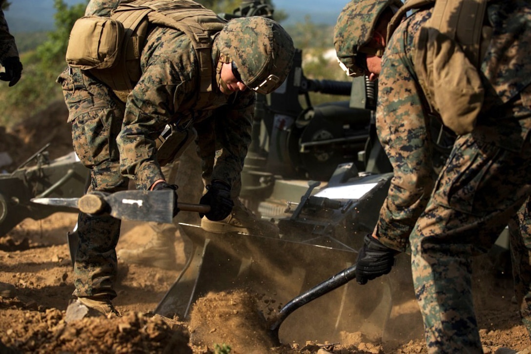 U.S. Marines dig in the M777-A2 Howitzer to stabilize the gun before a direct-fire exercise at Novo Selo Training Area, Bulgaria, Sept. 22, 2015. U.S. Marine Corps photo by Lance Cpl. Melanye E. Martinez