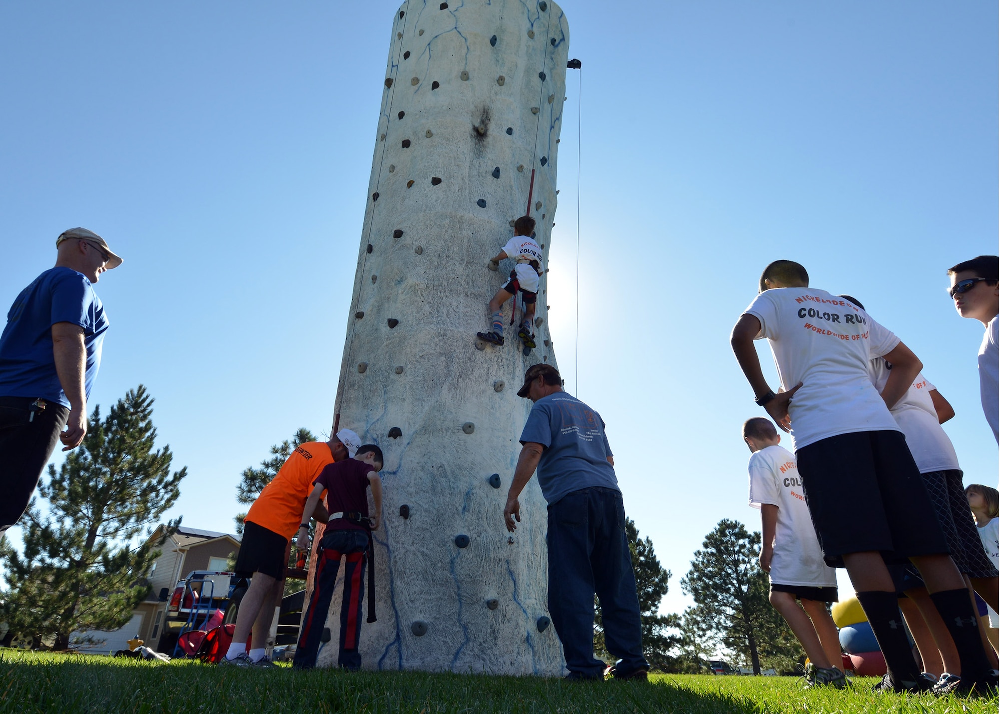 Children wait for their turn to climb a rock wall during the Worldwide Day of Play event hosted by the Youth Center at Peterson Air Force Base, Colorado, Sept. 26, 2015. The event featured a 2-kilometer color run, a healthy cooking competition and inflatable obstacle courses but also highlighted National Preparedness Month by featuring activities and booths from the American Red Cross, Ft. Carson’s Veterinary Clinic and the Humane Society, the Colorado National Guard, “Prepare Colorado” and the 21st Civil Engineering Squadron Fire Department. (U.S. Air Force photo/Staff Sgt. Debbie Lockhart)