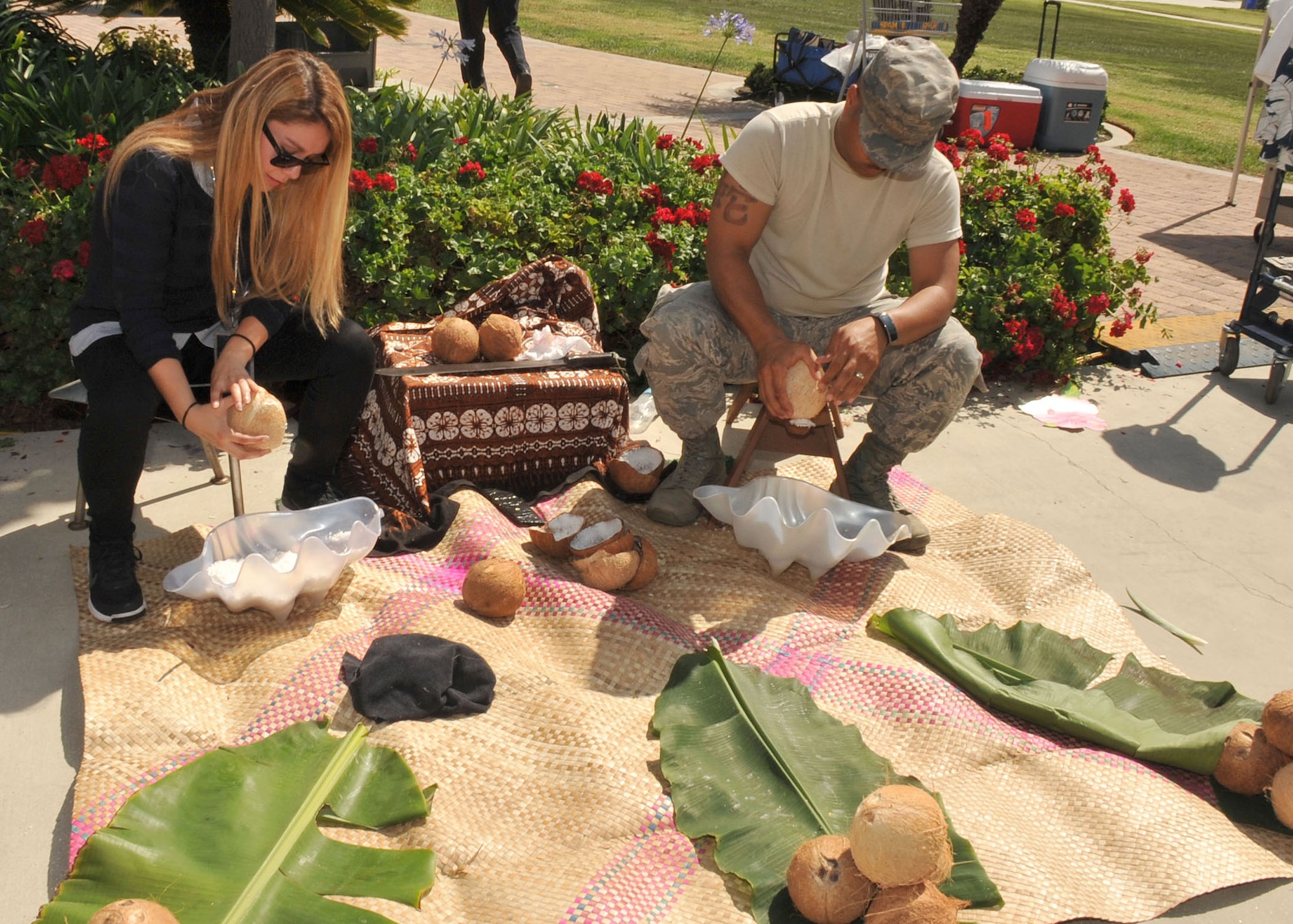 Participants try their hand at shaving coconuts at the Asian-Pacific American Council booth during diversity day activities at Los Angeles Air Force Base, Calif. (U.S. Air Force photo/Sarah Corrice)