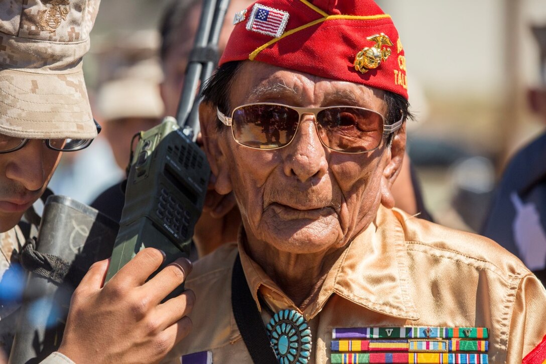 Navajo Code Talker Samuel T. Holiday, a native of Kayenta, Ariz., listens to an incoming radio transmission during a visit to Marine Corps Base Camp Pendleton, Calif., Sept. 28, 2015. The Navajo code talkers took part in every assault the U.S. Marines conducted in the Pacific from 1942 to 1945. They served in all six Marine divisions, Marine Raider Battalions and Marine parachute units, transmitting messages by telephone and radio in their native language that enemy forces were never able to break. (U.S. Marine Corps photo by Lance Cpl. Adrianna R. Lincoln 1st Marine Division Combat Camera/ Released)